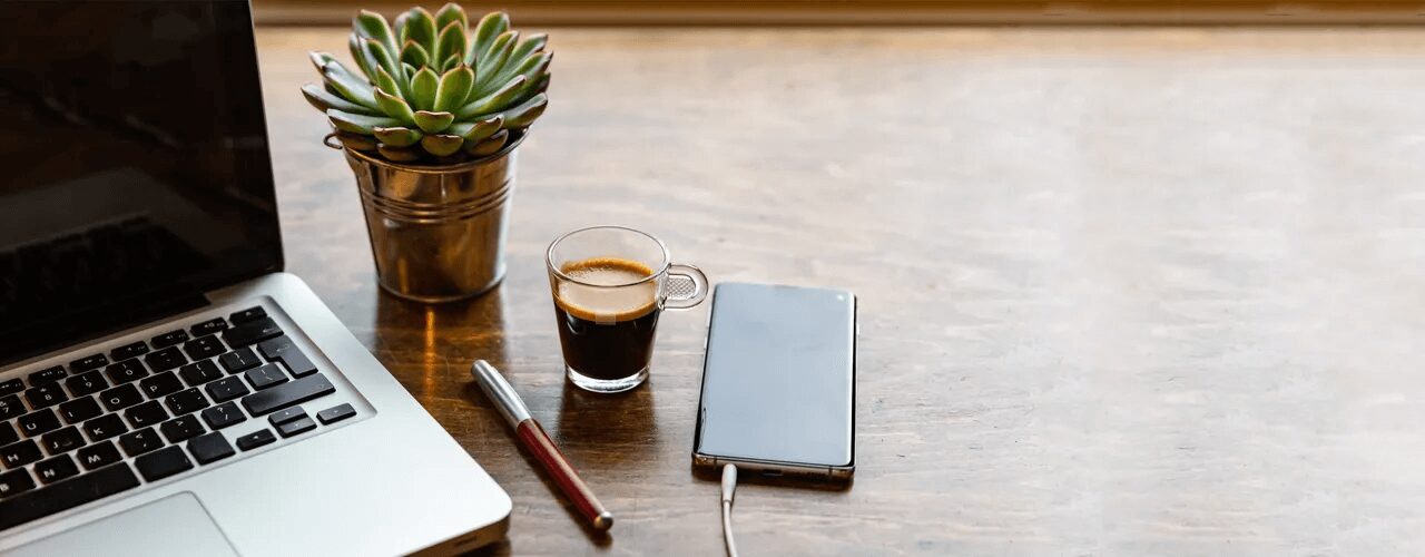 Computer Laptop and Mobile Phone on a Wood Office Desk