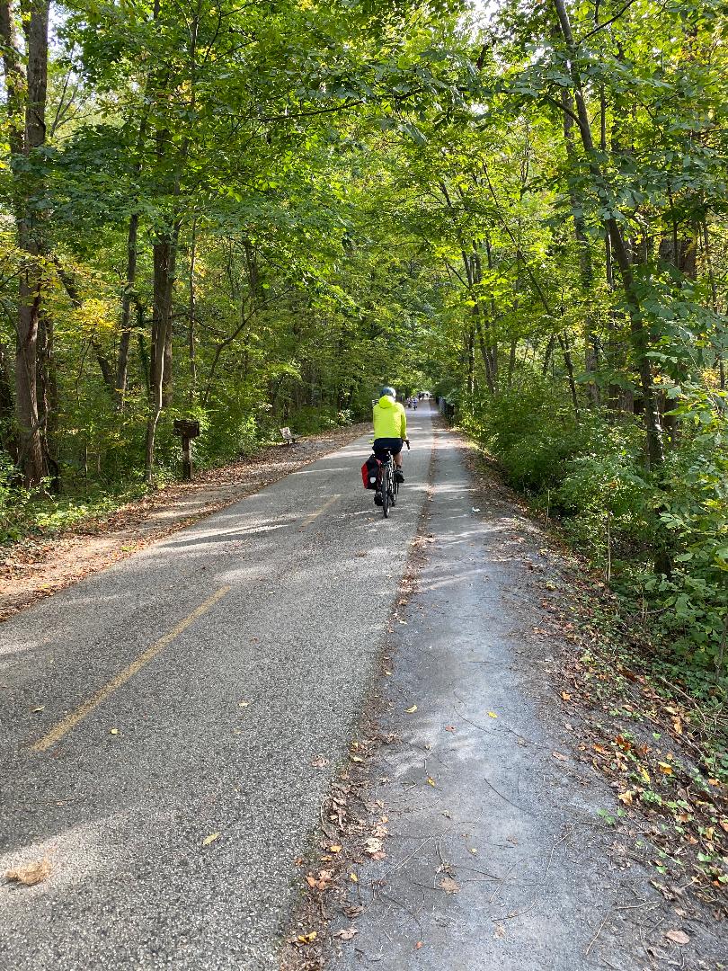 A man riding a bicycle on an empty road